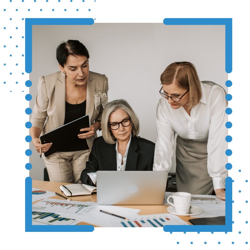 Female business women looking at computer with financial documents on the table
